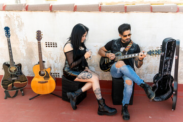 Couple of rockers making music on the roof of the house