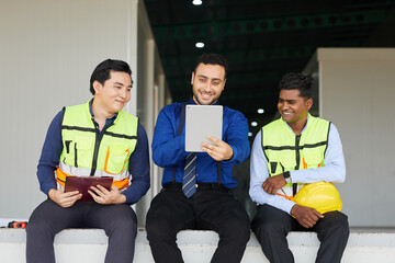 businessman and worker taking a break and video calling on tablet in the factory