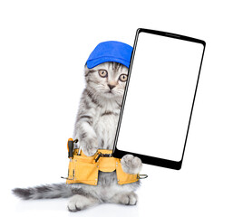 Poster - Funny cat worker wearing blue cap and toolbelt standing on hind legs and  shows big smartphone with white blank screen in it paw.  Isolated on white background