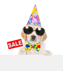 Poster - Golden retriever puppy wearing sunglasses, tie bow and party cap shows signboard with labeled 