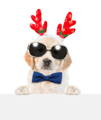 Aufkleber - Golden retriever puppy dressed like santa claus reindeer  Rudolf looking above empty white banner. isolated on white background