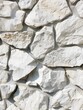 Detailed image of a white stone surface with natural cracks and a textured finish.