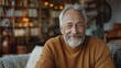 © Werckmeister - portrait of a senior man smiling and looks at camera, in living room background,