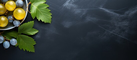 Aufkleber - Some organic gooseberries from the garden and a leaf on a blue gray plate and a dark slate background with copy space high angle view from above