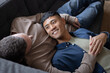 © ReeldealHD images - Gay couple at home relaxing on a sofa together