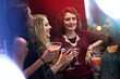 © peopleimages.com - Women, friends and cocktail with party in nightclub, event and conversation at happy hour. Group, club and drink with laughing, alcohol and smile with celebration for new year with reunion in night