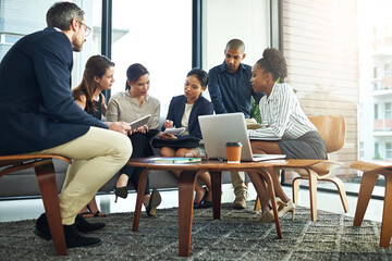 Laptop, meeting and teamwork with business people in lobby of office for discussion or planning. Collaboration, computer and project management with employee group in workplace for administration