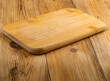 a wooden cutting board on a wooden floor with a wooden board on it.