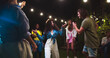 © ihorvsn - Joyful beautiful mixed-race girls dancing in garden at party. Caucasian girl in hat and boy having fun. African American female dance outdoor. Happy guy moving to music. Celebration concept
