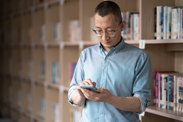 Wall Mural - people using mobile phone in library