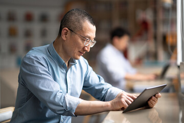 Wall Mural - businessman using tablet in library