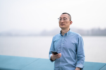 businessman using mobile phone in park