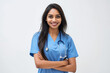 © Ирина Щукина - Attractive indian female doctor smiling on white background. Woman wearing blue scrubs and stethoscope.