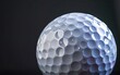 © OLGA - Close-up of a golf ball against a dark background.