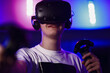 The player plays the game using virtual reality. Neon style.