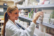 © peopleimages.com - Happy woman, pharmacist or reading medicine for stock check at pharmacy for pills information. Healthcare, medical internship or girl by shelf for pharmaceutical drugs for boxes or product inventory