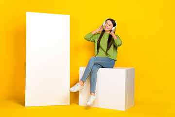 Sticker - Full body photo of young girl listen radio earphones meloman mp3 promo sit podium isolated over yellow color background