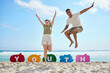 © peopleimages.com - Couple, speech bubble and portrait, people and outdoor for fun holiday, support and happy for summer. Energy, youth and excited man and woman jumping with hands up, text and cheerful for weekend