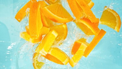 Canvas Print - Freeze Motion of Orange Slices Falling into Water, Splashing.