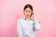 © Katcha - Young asian woman using fingers with one hand to touching and massaging forehead while suffering headache