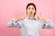 © Katcha - Young asian woman using both hands with fingers to thumbs up gesture with surprised and excited face
