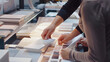 © Generative AI - interior designer and customer choosing furniture and flooring materials from samples at design shop : Generative AI