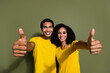 Portrait of two nice people show thumb up symbol wear t-shirt isolated on khaki color background