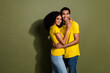 Portrait of two nice people toothy smile cuddle wear t-shirt isolated on khaki color background