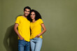 Portrait of two nice people toothy smile empty space wear t-shirt isolated on khaki color background