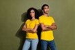 Portrait of two nice people crossed arms wear t-shirt isolated on khaki color background