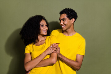 Wall Mural - Portrait of two nice people cuddle look each other wear t-shirt isolated on khaki color background
