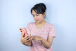 © Aufa Fahmi  - smiling expression asian woman reading good news on her smart phone on white background