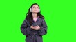 © Nataliya - Sad woman wearing headphones and holding mobile phone on the chroma key