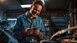 © Studio Nova - Mechanic Smiling at Smartphone