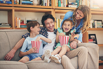 Canvas Print - Happy family, relax and laughing with popcorn for comedy movie, weekend or holiday on living room sofa at home. Mom, dad and young children with smile for funny show or streaming service at house