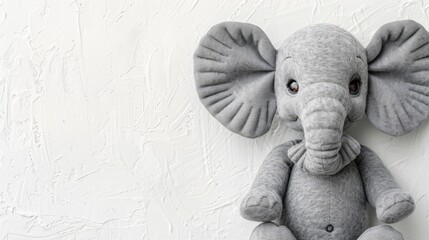 Poster -  A gray stuffed elephant atop a white wall Adjacent is another white wall Behind both, a white-painted wall