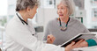 © peopleimages.com - Senior doctor, tablet and discussion with patient for healthcare prescription or diagnosis at hospital. Mature medical professional talking to elderly female person on technology for consultation