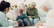 © peopleimages.com - Sympathy, grief and elderly woman with family crying for loss, sadness or depression in living room. Mental health, emotions and senior female person comforting friend in sorrow for empathy at home.