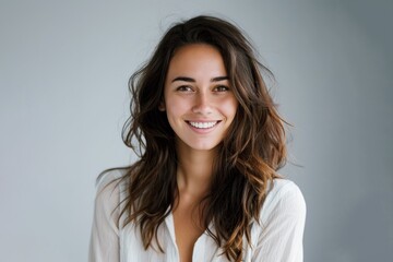 Wall Mural - smiling happy attractive young woman posing in studio shot on grey background