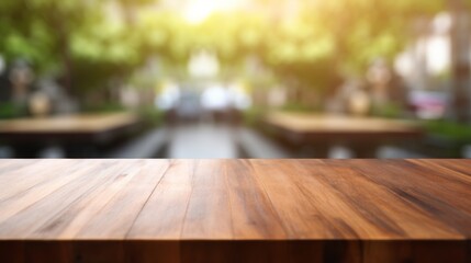 This image features a sleek wooden table top with a vibrant green blur of trees in the background, suggesting nature's touch