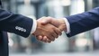 © leftmade - Professional Handshake Close-up, Corporate Agreement in Urban Setting