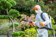 © Tomasz Zajda - Gardener Spraying Tree With Protective Suit