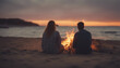 © abu - Lovely couple sitting at the beach near the bonfire and watching the sunset