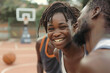 © Areesha - Outdoors Activity. African couple girl dribbling while guy defensing backdoor on basketball court smiling happy