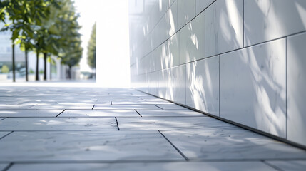 Poster - large modern building with high white wall near empty sidewalk covered with grey stone tiles on city street in spring : Generative AI