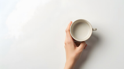 Poster - Female hand holding empty coffee cup isolated on white background with clipping path top view flat lay : Generative AI