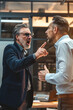 © MNStudio - Angry office boss shouting, arguing and threatening his employee. Anger management concept.