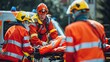 © At My Hat - Three emergency workers are tending to a person in an orange jacket. The scene is tense and serious, as the workers are focused on providing medical assistance to the injured person