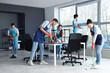 © Pixel-Shot - Team of young janitors cleaning in office
