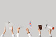 © Pixel-Shot - Hands holding ballot box, UK flag, passport and megaphone on white background. Election concept